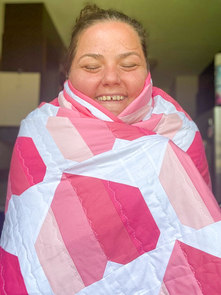 Happy Ashley all snuggled up - Ashley's Infinite Hears Quilt - The Little Bird Designs